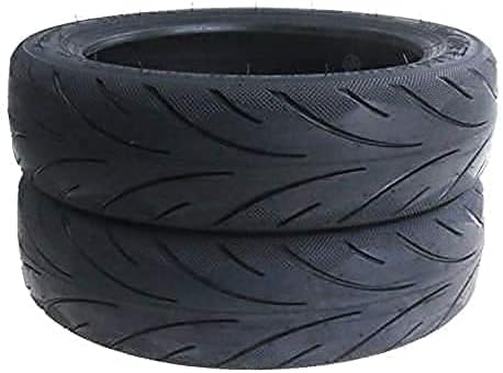 Two black tires with tread pattern on a white background