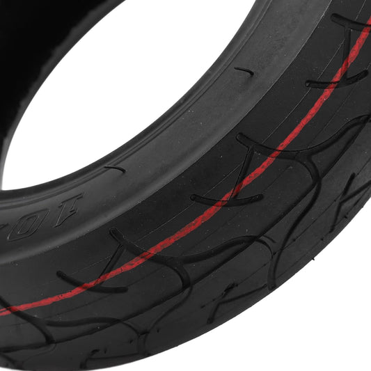 Close-up of a black tire with red accents on a white background