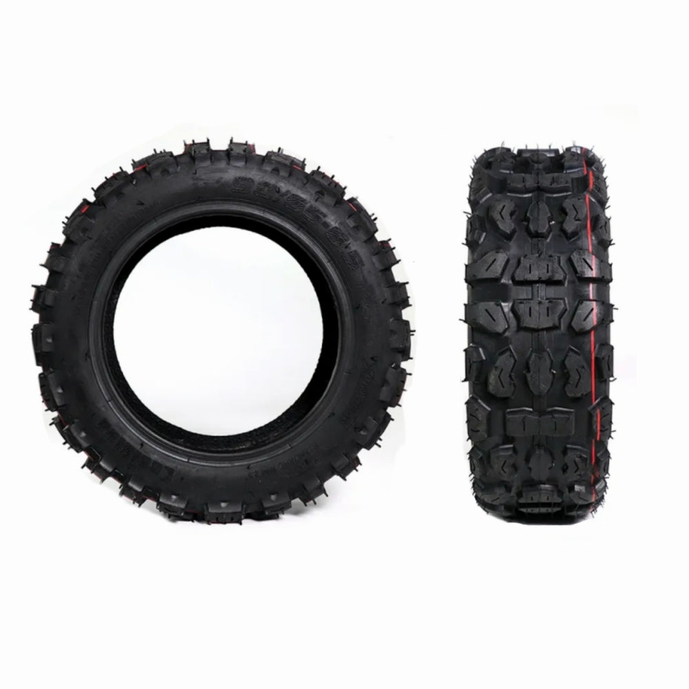 Two black off-road tires with tread patterns on a white background