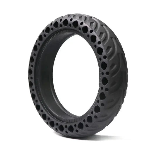 Black off-road tire with unique tread pattern on a white background
