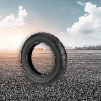 Tire with a scenic view of a field and trees through its tread pattern.