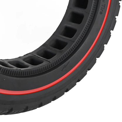 Close-up of a black tire with red rim on a white background