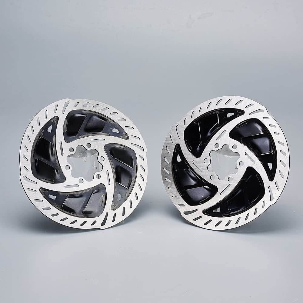 Two metallic disc brake rotors on a gray background