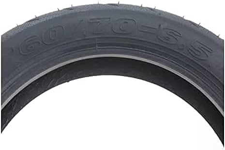 Close-up of a black tire with size marking on a white background