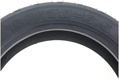 Close-up of a black tire with size marking on a white background