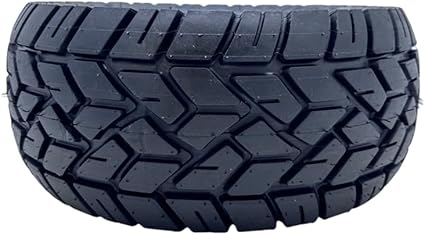 Close-up of a tire with tread pattern on a black background