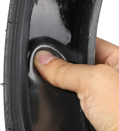 Close-up of a finger pressing on a black tire with tread pattern