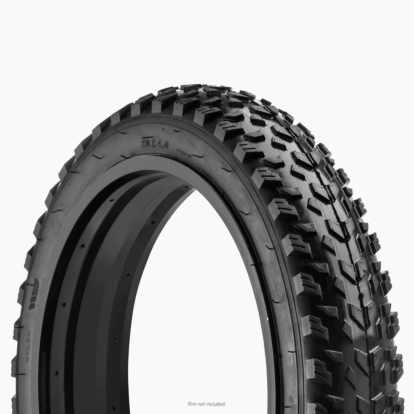 Close-up of a black off-road tire with tread pattern on a white background