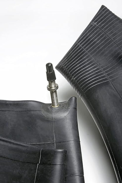 Close-up of a black tire with valve stem on a white background