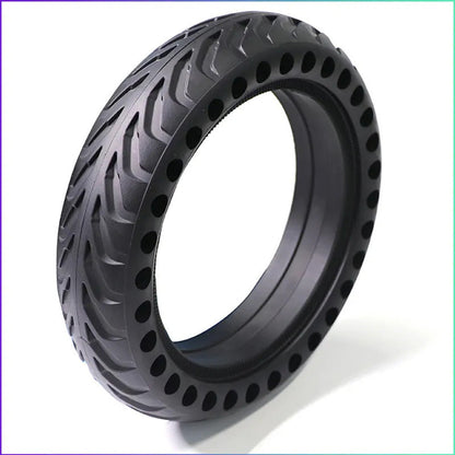 Black tire with unique tread pattern on a white background