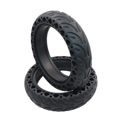 Two black off-road tires stacked on a white background
