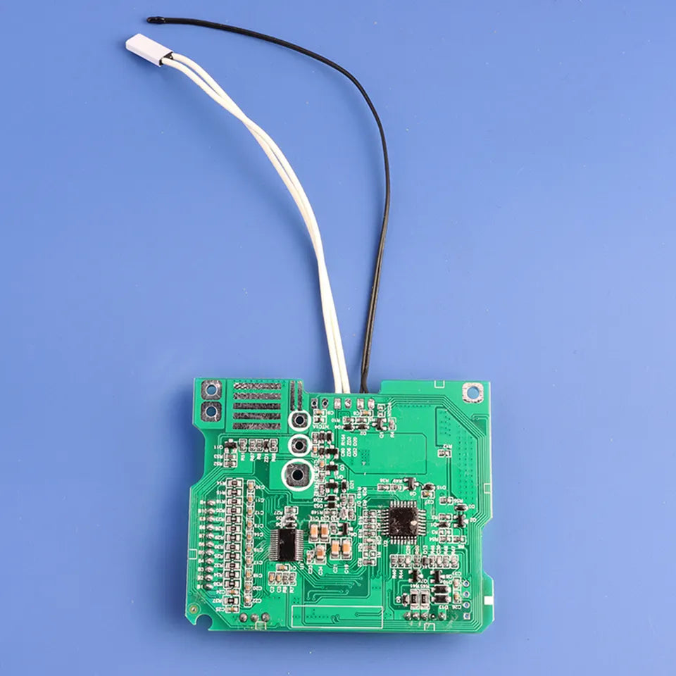 Green electronic circuit board with wires on a blue background