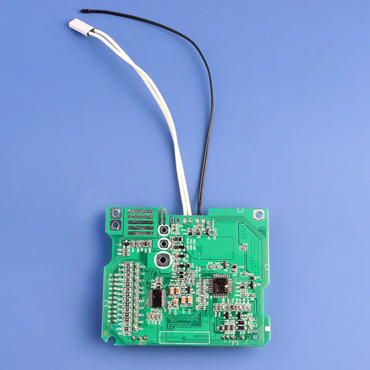 Green electronic circuit board with wires on a blue background