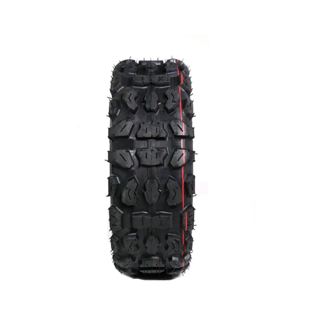 Black off-road tire with prominent tread pattern on a white background