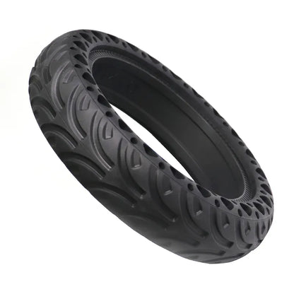 Black tire with unique tread pattern on a white background