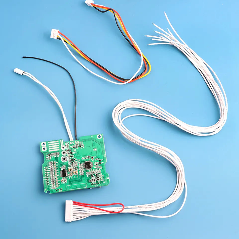 Green electronic circuit board with wires on a blue background