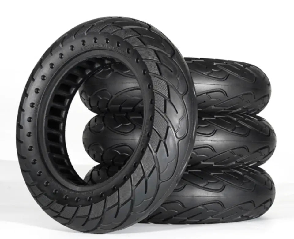 Set of black off-road tires with tread patterns on a white background