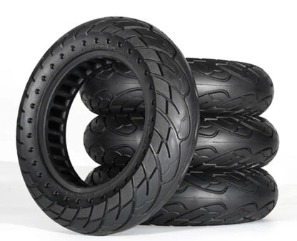 Set of black off-road tires with tread patterns on a white background