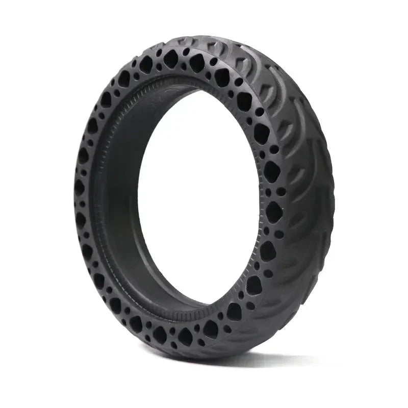 Black off-road tire with unique tread pattern on a white background