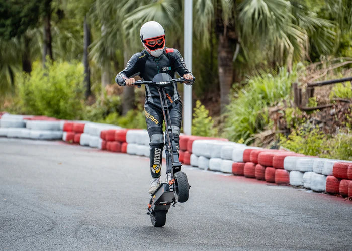 Person riding a KUKIRIN G4 Electric Scooter on a track in Vancouver with greenery in the background