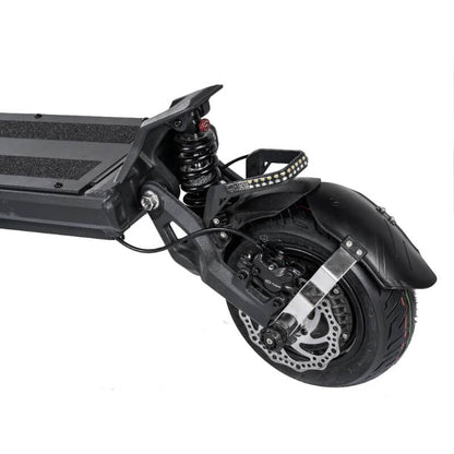 Close-up of a scooter's wheel and suspension system on a white background