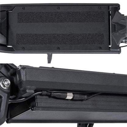 Close-up of a black motorcycle storage tray with mounting hardware on a white background