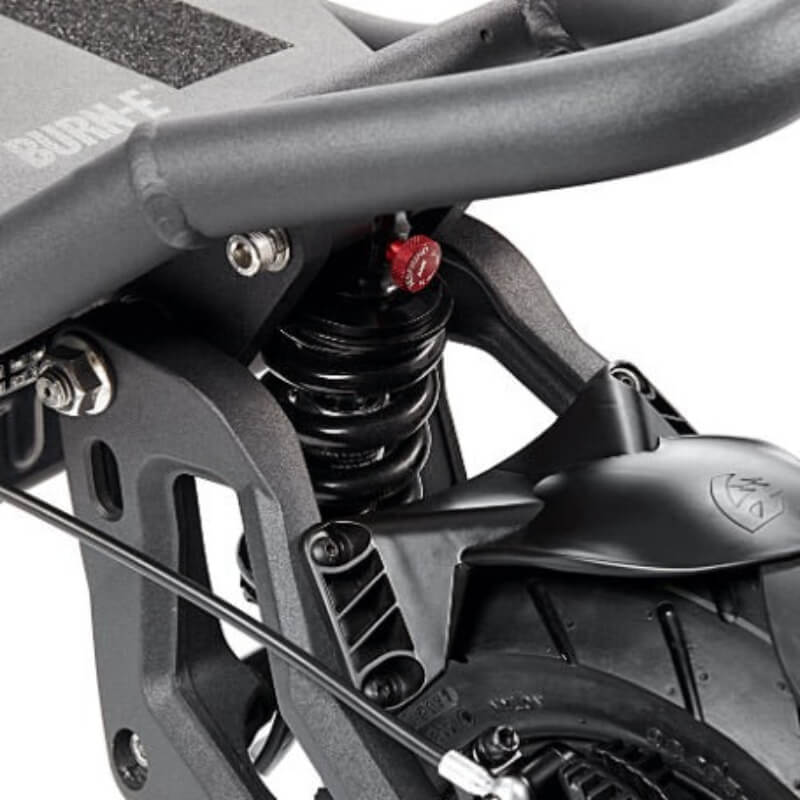 Close-up of a motorcycle suspension system with visible branding on a white background