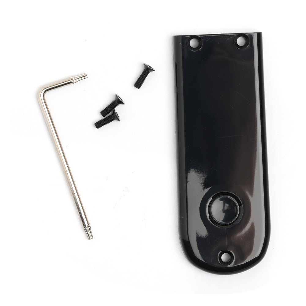 Black guitar pickup cover with screws and a tool on a white background