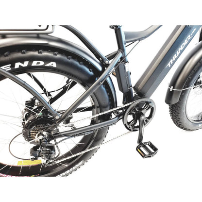 Close-up of a bicycle with a focus on the chain and wheel, featuring brand names.