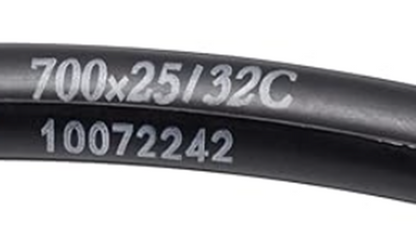 Black bicycle tube with size and serial number text on a white background