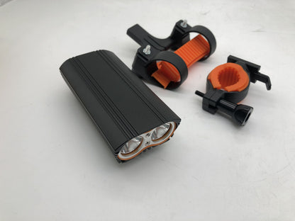 Black flashlight with orange accents on a white background