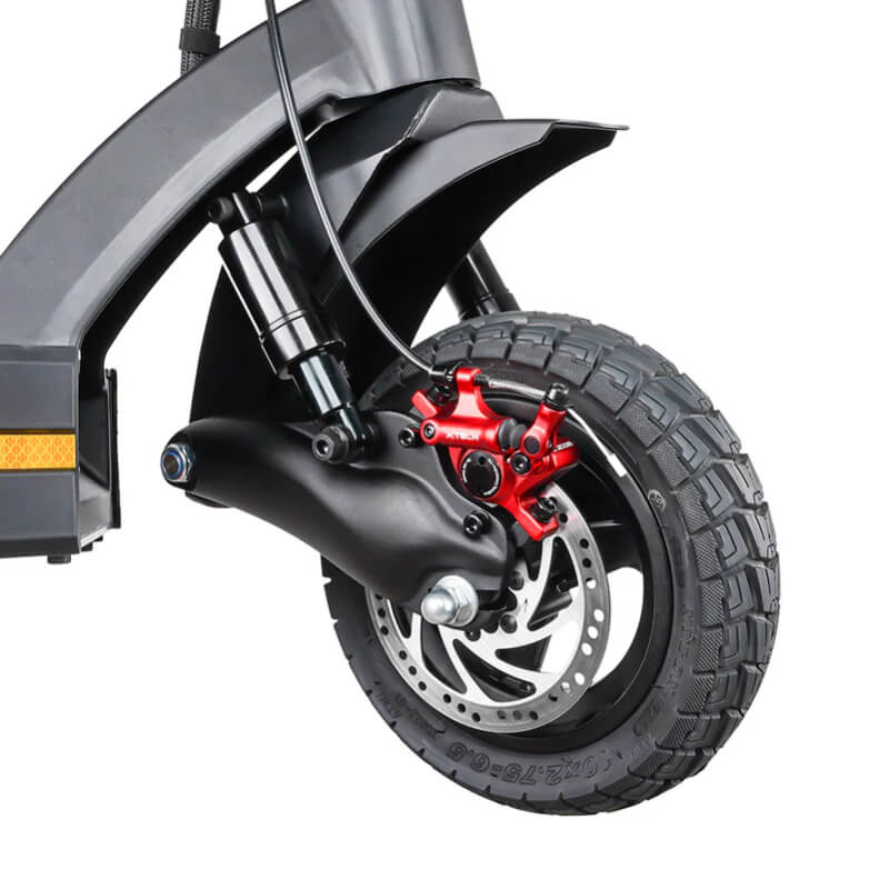 Close-up of a motorcycle wheel with a red brake caliper on a white background