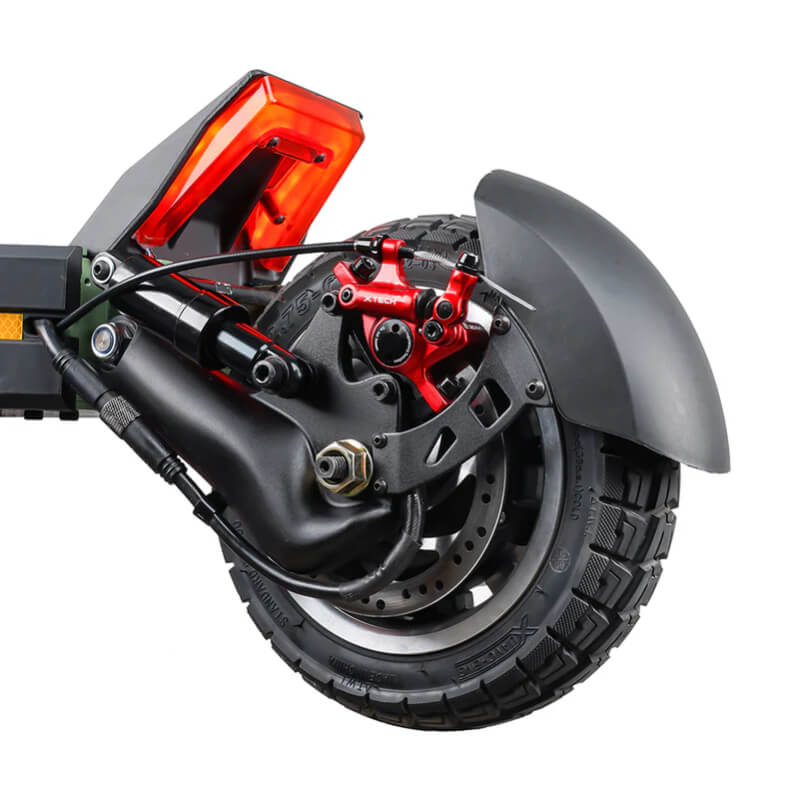 Close-up of a motorcycle wheel with red brake caliper on a white background