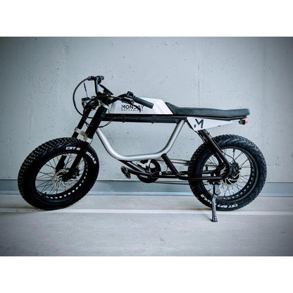 Small electric bike with 'Money' branding on a gray background