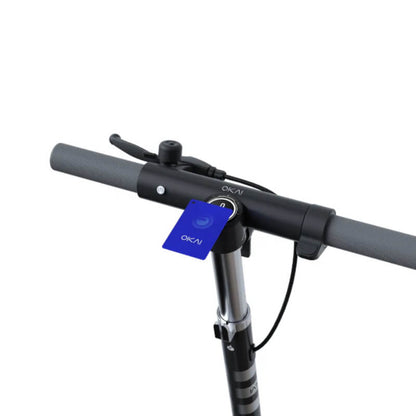 Close-up of a scooter handlebar with a blue OKAI tag on a white background