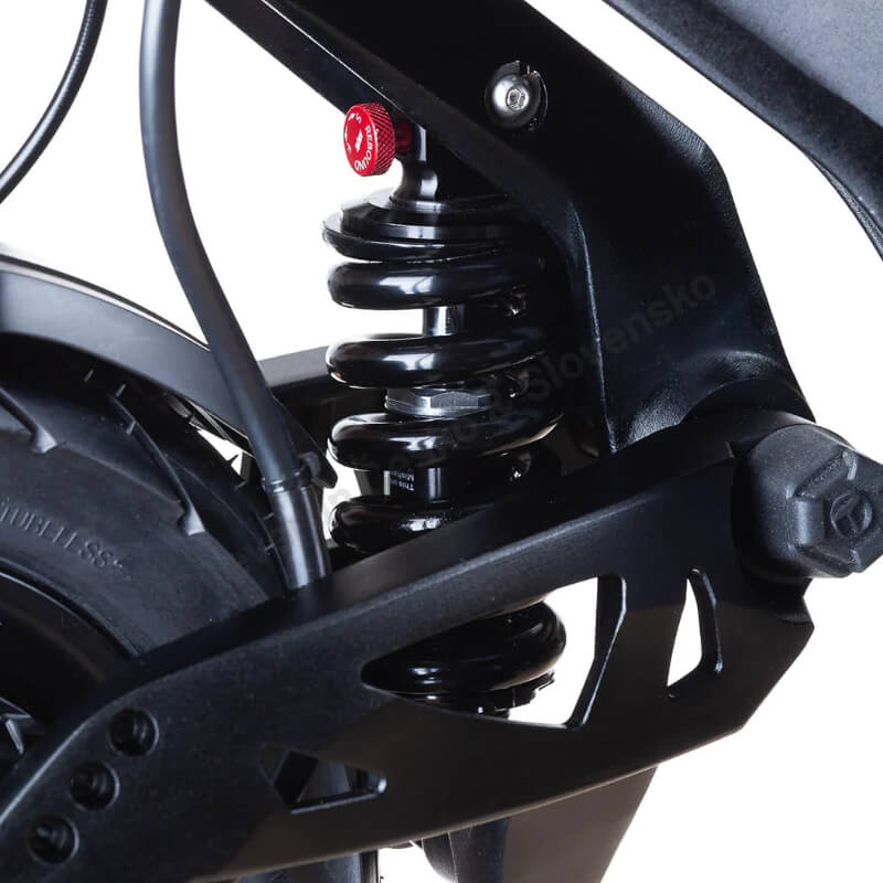 Close-up of a motorcycle suspension system with a visible brand name on a white background