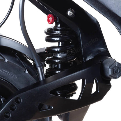 Close-up of a motorcycle suspension system with a visible brand name on a white background