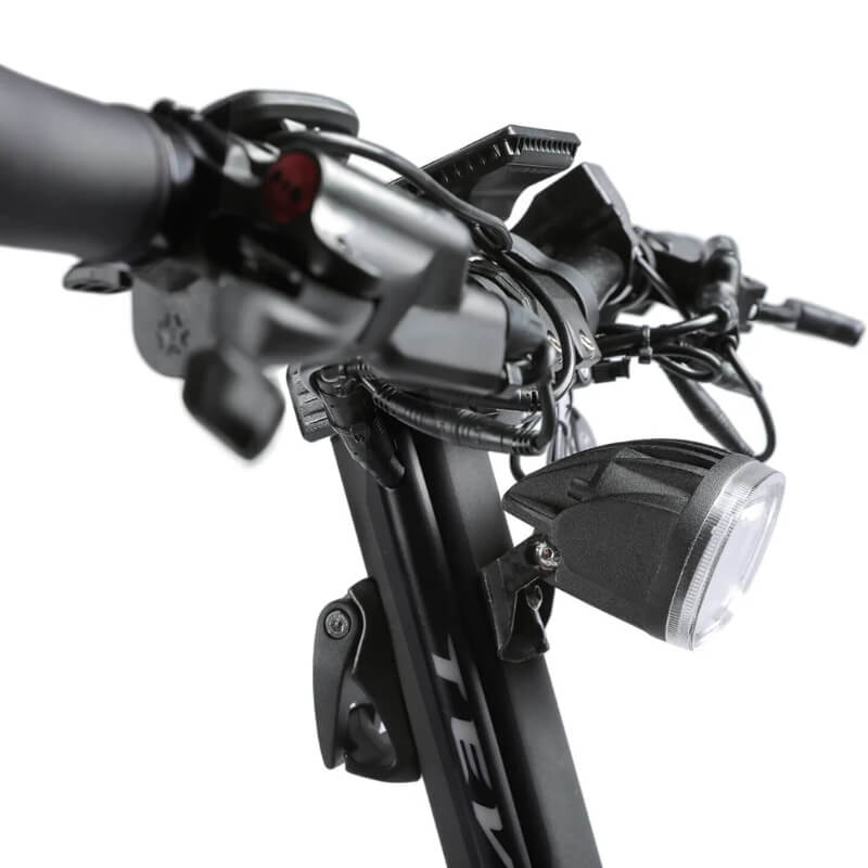 Close-up of a bicycle handlebar with lights and controls on a white background