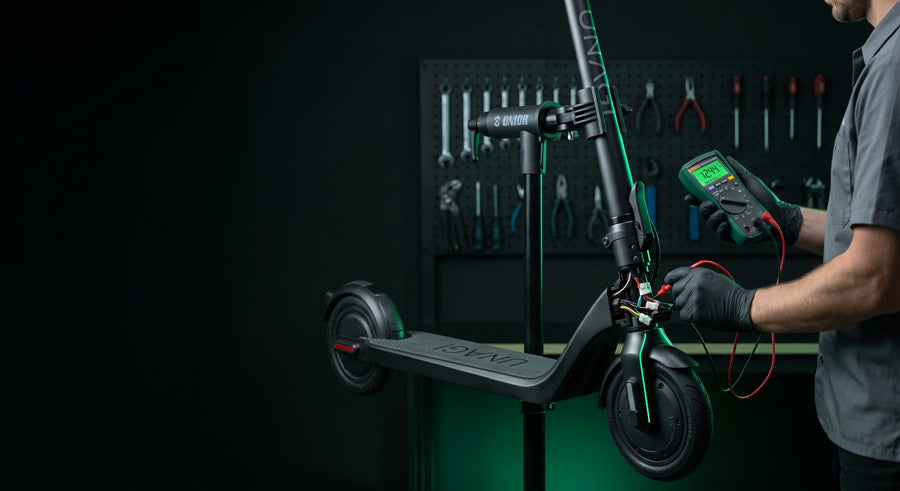 Technician diagnosing an electric scooter on the ProMechBC workbench