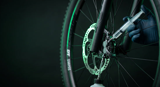 Hydraulic disc brake caliper and rotor being serviced on an electric bike