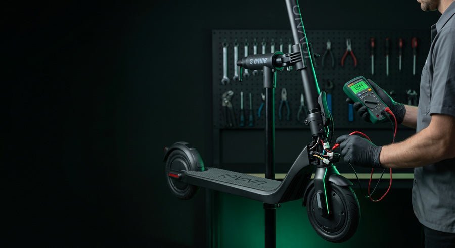 Technician diagnosing an electric scooter on the ProMechBC workbench